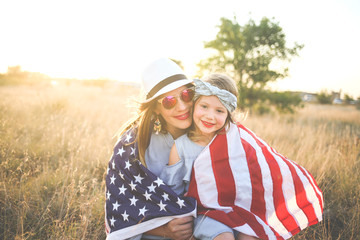 Patriotic mother and daughter with American flag