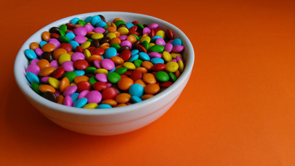 Colorful confetti on orange background