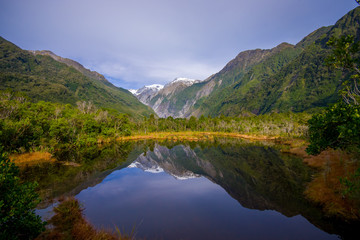 Fototapeta na wymiar Small pond peters pond with reflection of mountain glacier Franz Josef Glacier in New Zealand
