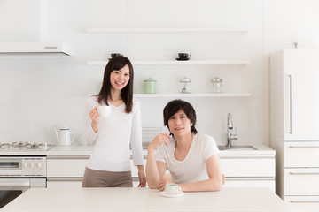young asian couple relaxing in kitchen