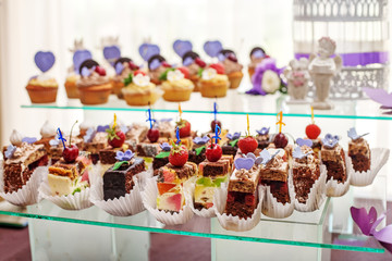 Desserts on a glass container. The concept of food, party and wedding.