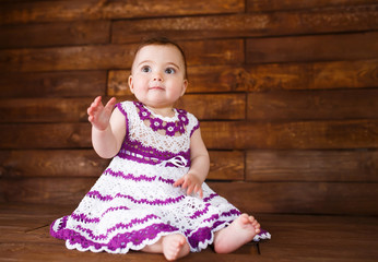 Cute little girl on a wooden background.