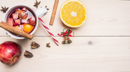 Fototapeta na wymiar New Year's and Christmas decoration with ingredients for preparation mulled wine, cinnamon and cloves, lined Border on a white wooden rustic background, space for text, top view