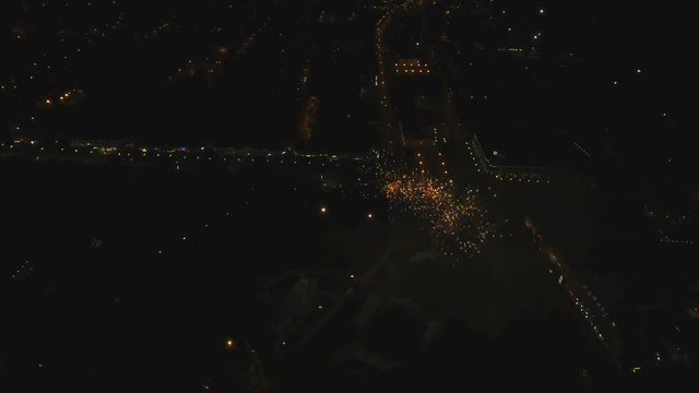 Aerial view Beautiful fireworks video from the drone in the night sky on celebration. Sparks. Fireworks are a class of explosive pyrotechnic devices used for aesthetic and entertainment purposes