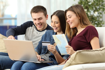 Fototapeta premium Friends planning and buying a travel on line