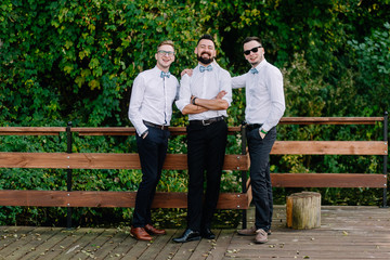 Portrait of successful and beautiful men in white shirts. Friends of the groom. Successful