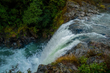 Water from volcano Mt Ruapehu forms Tawhai Falls in Tongariro National Park, New Zealand, lateral view