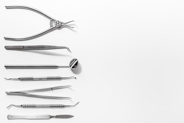 teeth care with dentist instruments in doctor's office white background top view mock-up