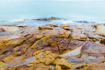 Colourful rocks and water at Diamond Head coast, Australia