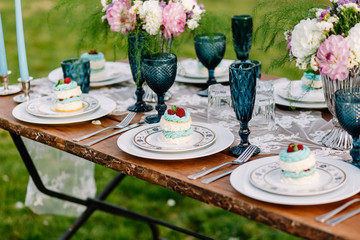 Decorated wedding table with cakes in the garden