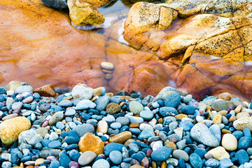 Colourful rocks and water at Diamond Head coast, Australia