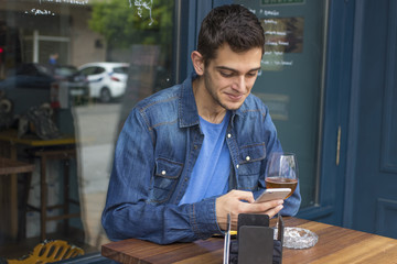 young man with the cellphone in the bar
