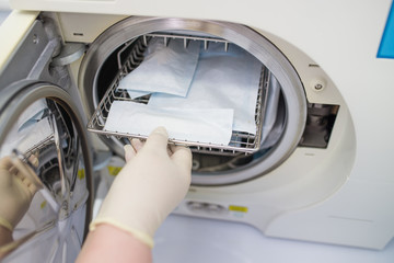 Dental assistant using Sterilization systems. Preparation instruments for cleaning