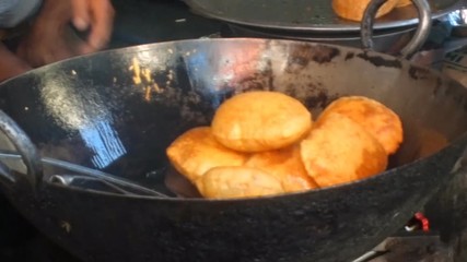 Indian doughnuts are cooked in hot oil. Action cook street cafe
