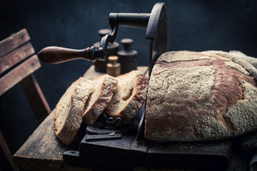 Tasty loaf of bread with flour and crumbs