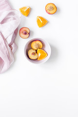 tropical peach and orange fruits for fresh juice with towel white background top view space for text