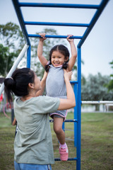 Obraz premium Little girl playing at the playground
