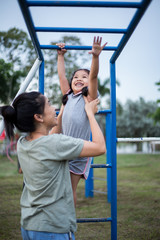 Obraz premium Mother and Little girl playing at the playground.
