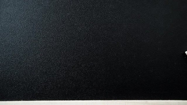 Blackboard with chalk piece as background texture. Empty blank black chalkboard. Dolly sliding shot 4K ProRes HQ codec