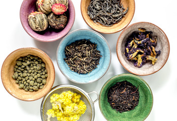 Tea-party with different herbal tea on white desk background flat lay pattern