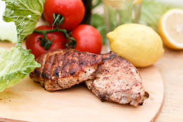 Сhicken breast grilled on a wooden Board. Chicken chili steak on the background with vegetables and black soda and lemonade, food photography