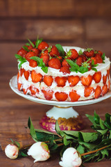Strawberry cake on a wooden background.