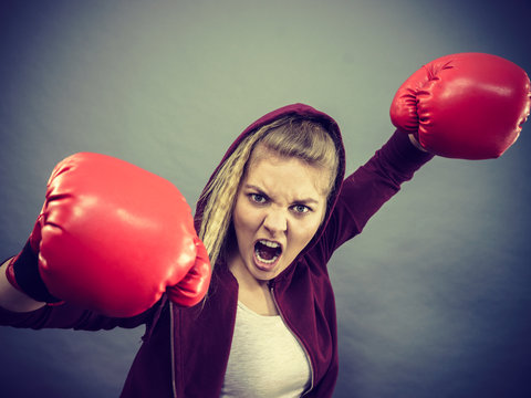 Angry woman wearing boxing gloves