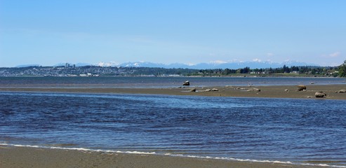 Waves move into Drayton Harbor on an early summer afternoon,  with a view of White Rock in Canada