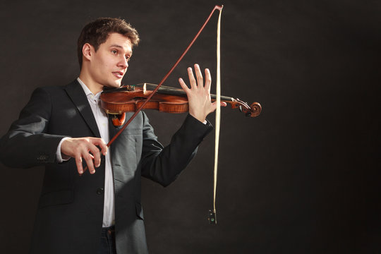 Young man violinist shocked, broken bow
