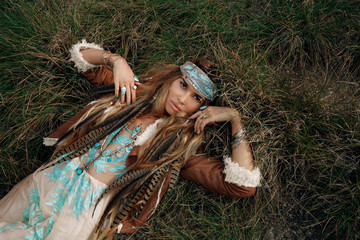 beautiful young boho girl in jacket lying down on grass © zolotareva_elina