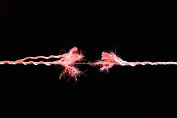 Tearing the rope in the middle of the frame pink color - obrazy, fototapety, plakaty