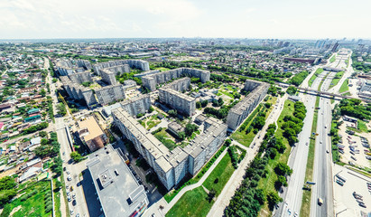 Aerial city view with crossroads and roads, houses, buildings, parks and parking lots, bridges. Helicopter drone shot. Wide Panoramic image.