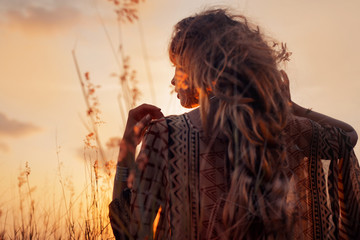 close up of beautiful young woman at sunset