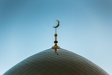 Golden minaret of the mosque. Symbol of Islam. The Golden Crescent.