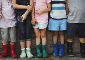 Group of kindergarten kids friends holding magnifying glass for explore