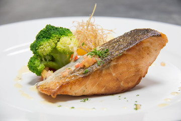  grilled salmon steak on mixedl vegetables with sauce