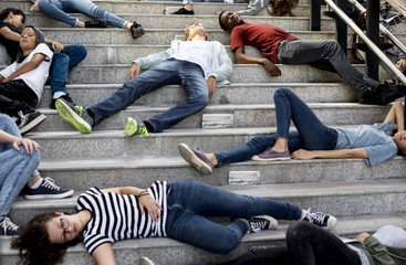 Young students sleeping on the staircase