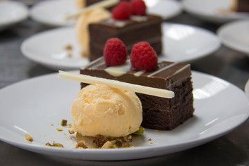  Chocolate layered cake topped with  raspberry and ice cream