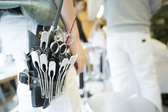 Tools that a hairdresser is wearing on his waist
