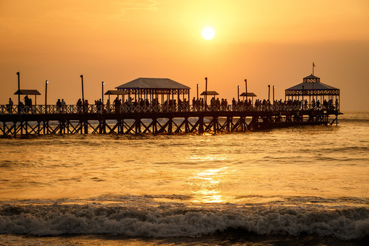 Sunset at pier of Huanchaco town, Peru