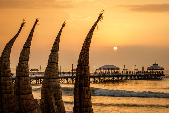 The sunset with traditional boat craft at Huanchaco town, Peru