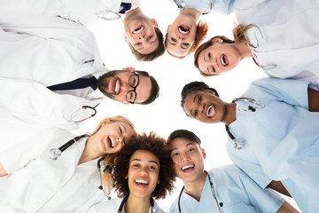 Fototapeta na wymiar Smiling Medical Team Standing Against White Background