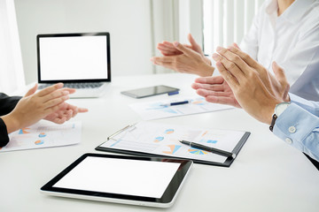 business seminar listeners clapping hands with documents having discussion in office