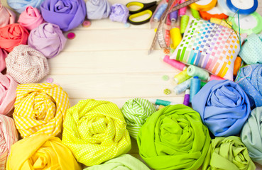 Accessories for sewing lie on a white background. Measuring tape, thread, fabric, needle bar and...