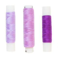 Mauve and purple thread. Isolated. White background.