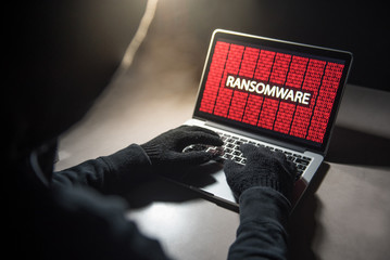 Male hacker hacking into computer operating system. Internet security malware virus Trojan...