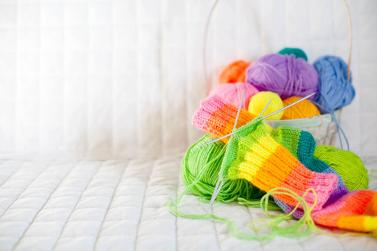 Closeup of basket with colorful yarn clews. Concept of freelance creative working and happy living