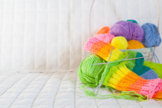 Closeup of basket with colorful yarn clews. Concept of freelance creative working and happy living