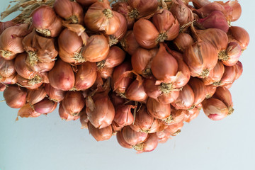 the shallots hang on wallpaper background © tumsubin