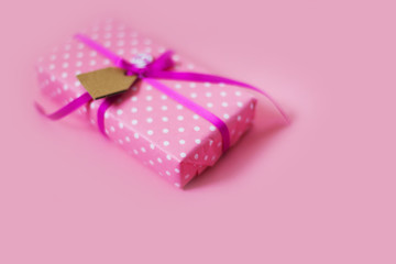Colored gift boxes with colorful ribbons. Pink background. Gifts for St. Valentine's Day or a birthday.